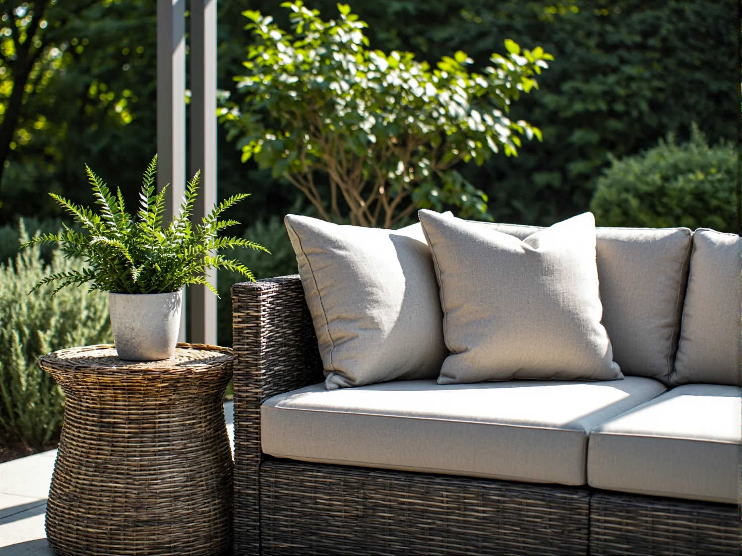 Nowoczesna aranżacja ogrodu z wykorzystaniem stylowych mebli rattanowych w naturalnych odcieniach.